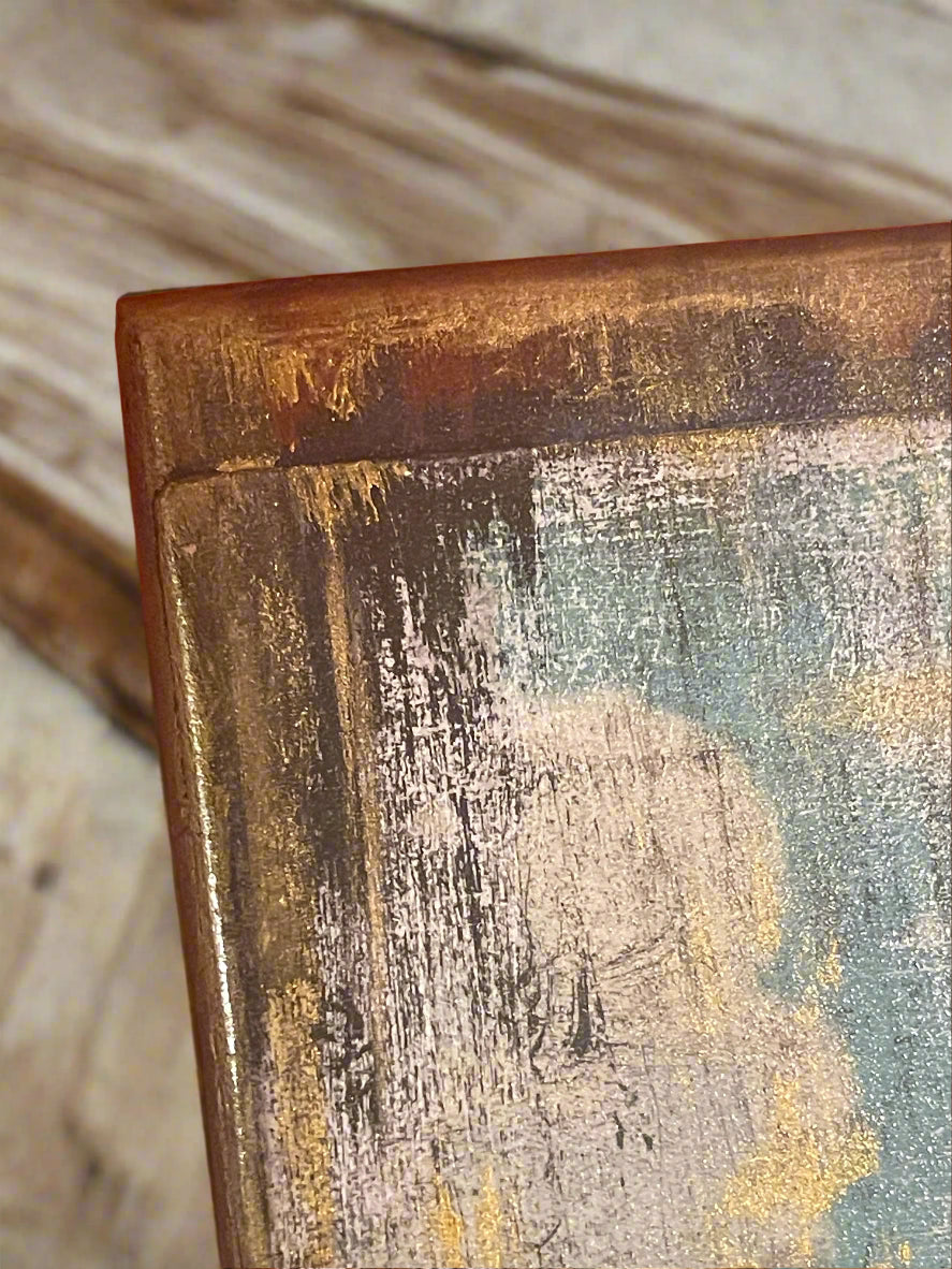 Close-up of the reflection of gold leaf and texture detail on one corner of the jewelry box.