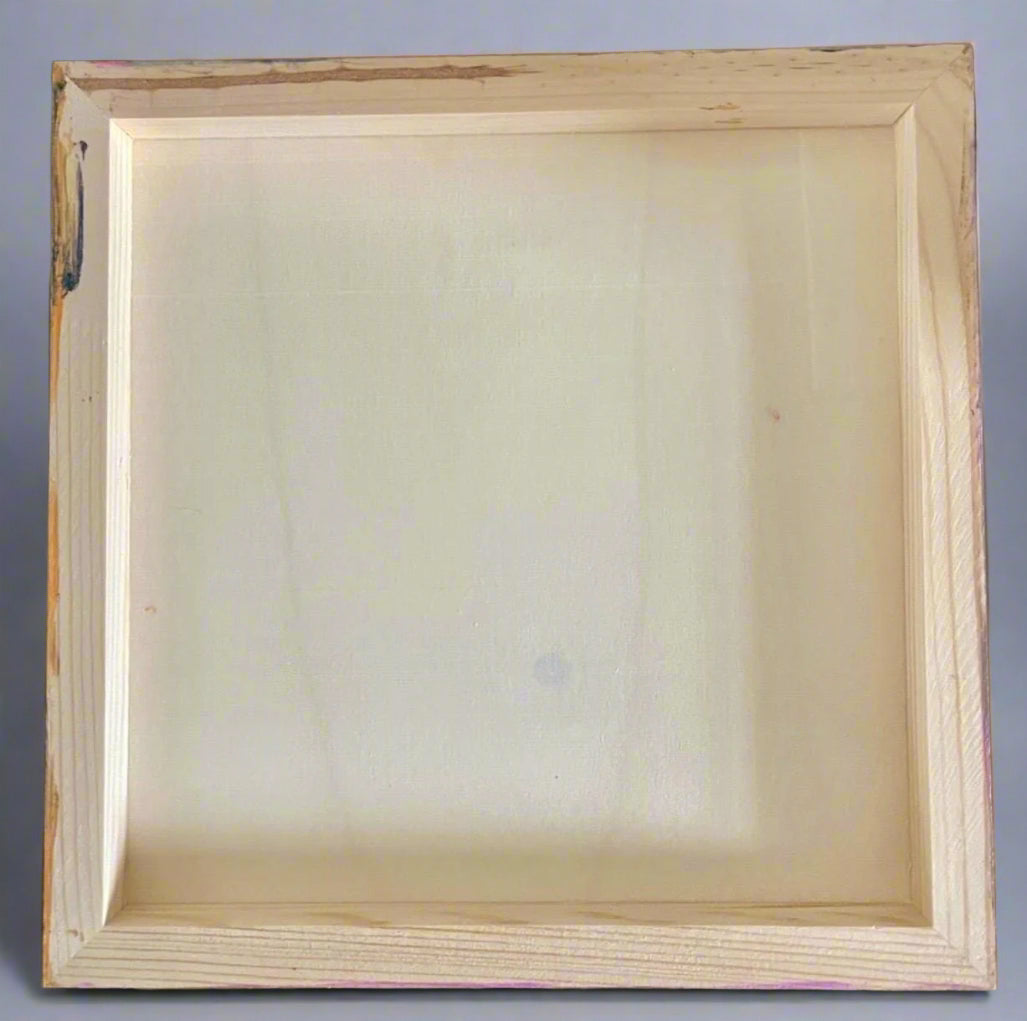 Plain wooden picture frame on a dark surface